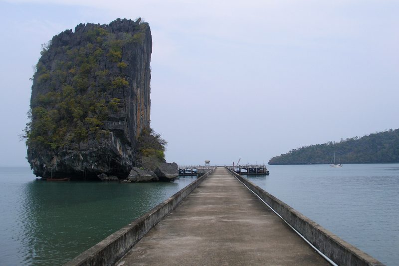 เกาะหินปูนสูงตั้งอยู่กลางน้ำข้างสะพานท่าเรือยาว